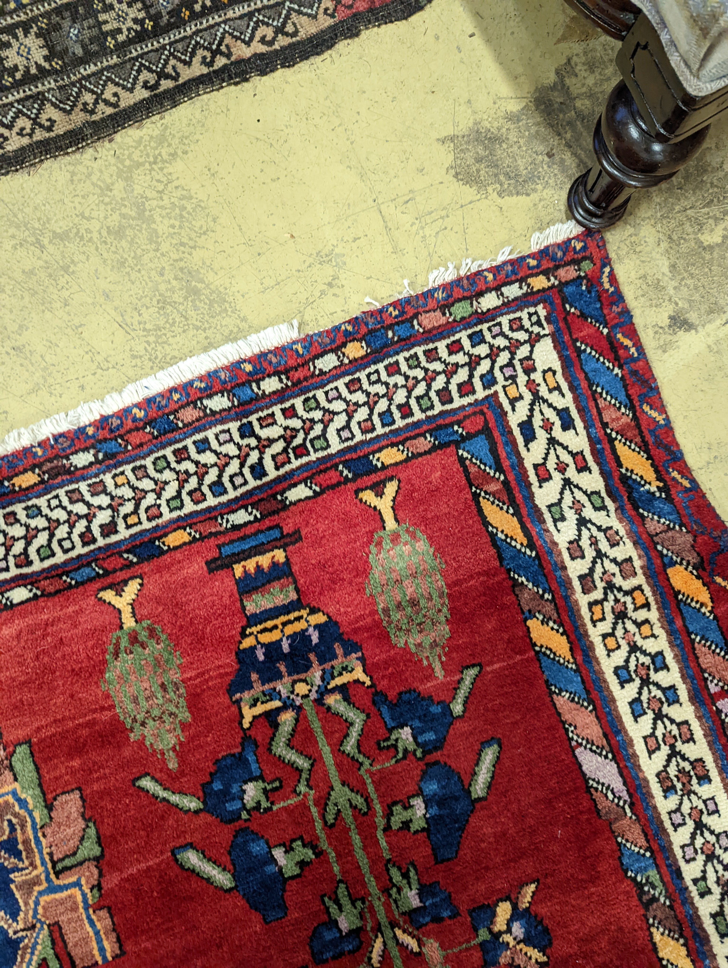 A Caucasian red ground rug, 240 x 168cm